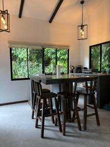 a dining room with a large table and chairs at Villas Calú in Talamanca +12 photos