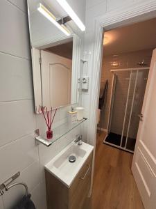 a white bathroom with a sink and a mirror at Loft anexo en chalet, con piscina de uso privado in San Juan