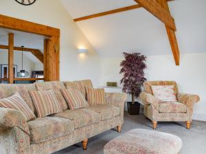 a living room with a couch and a chair at The Imaginary Barn in Hartland