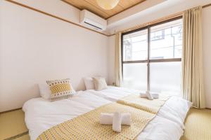 Llit o llits en una habitació de perfect life緑橋