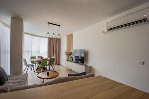 a living room with a couch and a table at City Center Apartments in Kŭrdzhali