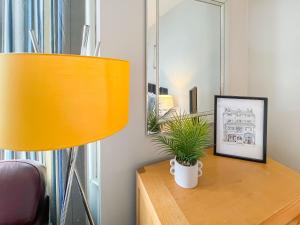 a desk with a lamp and a picture on it at Pier View Apartment 2 - Uk48502 in Skegness