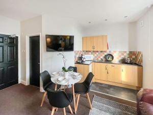 a kitchen and dining room with a table and chairs at Pier View Apartment 2 - Uk48502 in Skegness