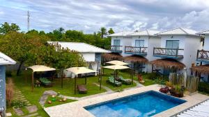 an aerial view of a resort with a pool and umbrellas at POUSADA CAJU DO MATO in Prado