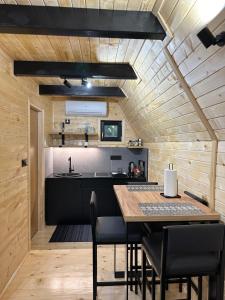 a kitchen and dining room with a table and chairs at Plivska vila 2 in Jajce +22 photos