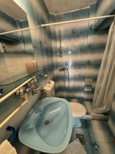 a bathroom with a blue sink and a toilet at ROOM 03 Villa KRIVOKAPIC in Budva +12 photos