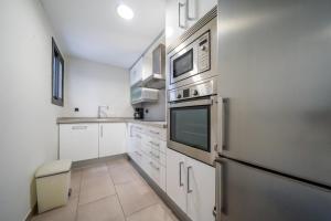 Kuchyňa alebo kuchynka v ubytovaní Apartaments Lamoga- Spai