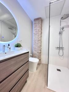a bathroom with a sink and a toilet and a mirror at EcoCasa 12PAX perfecta grupos, reforma lujo, junto parada Burjassot metrovalencia, cerca centro Valencia y playa, lavadora, secadora equipamiento total in Burjasot