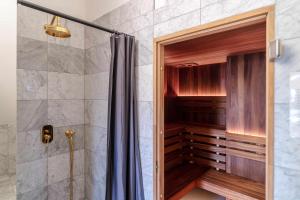 a bathroom with a shower with a glass door at Hotel Unicus Palace Old Town - Destigo Hotels in Krakow +54 photos