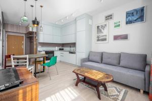 a living room with a couch and a table at Art Box - Gdańska Brzeźno in Gdańsk