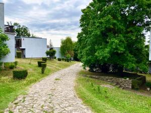 a gravel road in a yard with a tree at MRM Apartman Tihany in Tihany +8 photos
