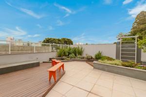 a patio with two benches on a roof at Urban Apt 601 Comfortable and Complete in Caxias do Sul