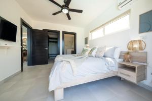 a bedroom with a bed and a ceiling fan at Ocean View, Style, Freedom in Sosúa +14 photos