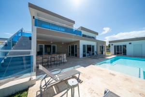 a villa with a swimming pool and a house at Ocean View, Style, Freedom in Sosúa