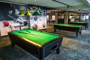 a billiard room with two pool tables in it at Bel Mare Baltic Prestige Apartment in Międzyzdroje