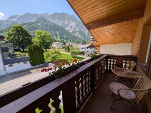 a balcony with chairs and a view of mountains at Montahaus Retro Apartments in Vandans