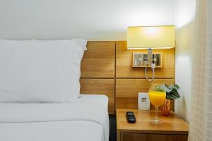 Cama ou camas em um quarto em Intercity Vinhedo