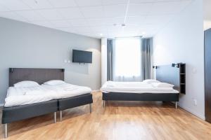 Postel nebo postele na pokoji v ubytování ApartDirect Arlandastad