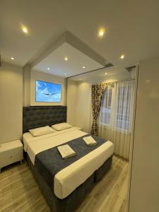 a bedroom with a large bed and a window at Ali Baba APART OTEL in Gökçeada