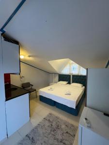 a small room with a bed and a window at Ali Baba APART OTEL in Gökçeada