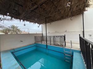 a swimming pool on the roof of a building at A big house -Isteraha- in Malham