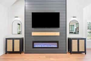 a living room with a tv and a fireplace at Creekside Cabin, Sauna, Near Wineries and BJ Reece in Talking Rock