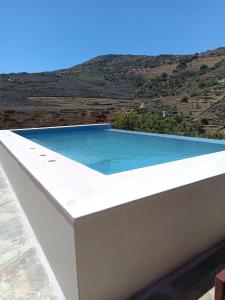 a swimming pool on the roof of a house at Celini villa Tinos in Krokos +78 photos