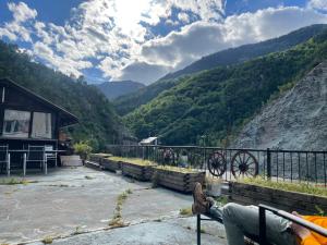 a person sitting on a bench looking at a mountain at Home 2 in Grengiols