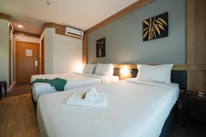 Cama ou camas em um quarto em Intercity Vinhedo