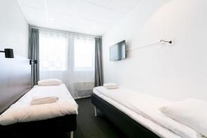 Postel nebo postele na pokoji v ubytování ApartDirect Arlandastad