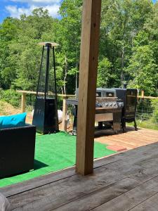 a play area with a playground with a table and a grill at Three Bears in Pikeville