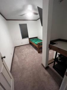 a small room with a bed and a table at Three Bears in Pikeville +21 photos