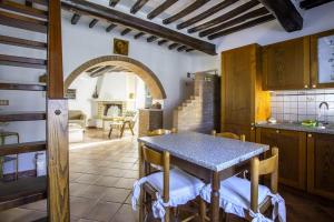 a kitchen with a table and chairs in a room at Apartment in the medieval village in Montefollonico