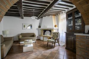 a living room with a couch and a fireplace at Apartment in the medieval village in Montefollonico