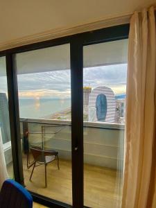 a room with a window with a view of the city at I LiKE ORBI CiTY in Angisa