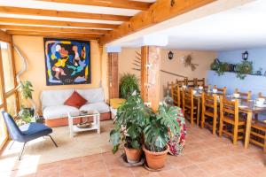 a living room with a couch and a table and chairs at Casa Guaranatura alojamiento y barrancos in Bierge