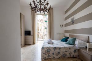 a bedroom with a bed and a chandelier at blu sea in La Spezia