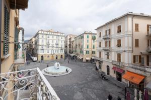 a view from a balcony of a street with a fountain at blu sea in La Spezia