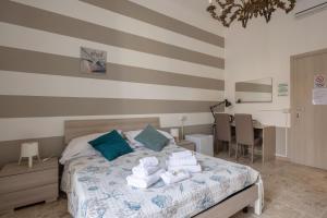 a bedroom with a bed with towels on it at blu sea in La Spezia +3 photos