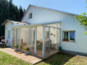 a house with sliding glass doors on a patio at Chata za hubičku in Třemešné