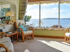 a living room with a view of the ocean at Sea Cottage in Turnchapel