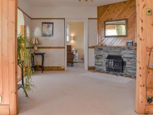 an open living room with a stone fireplace at Sea Cottage in Turnchapel