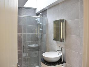 a bathroom with a sink and a shower at Teddys Cottage - Uk44685 in Burnopfield