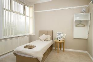 a small bedroom with a bed and a window at Hotel Sofia Blackpool in Blackpool +52 photos
