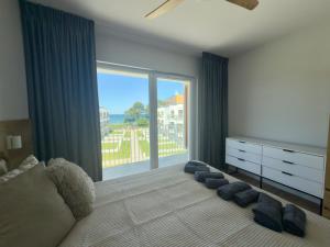 a bedroom with a bed and a large window at BalticBreeze II in Gąski +11 photos