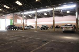 a parking lot with several cars parked in it at Colonial Palace Hotel in Pará de Minas