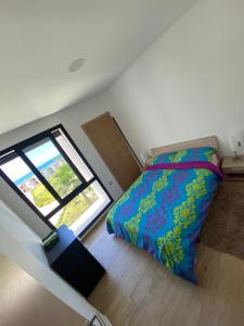 a small bedroom with a bed and a window at Prestigia plage des nations in Sale