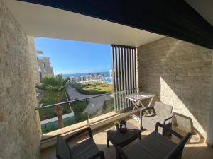 a balcony with chairs and a view of the ocean at Prestigia plage des nations in Sale