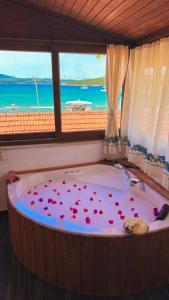 a bath tub with a bunch of roses in it at Pangea Sığacık Suite Hotel & Bistro in Seferihisar