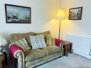 a living room with a couch and a lamp at Atlantic House - 27665 in Port Isaac